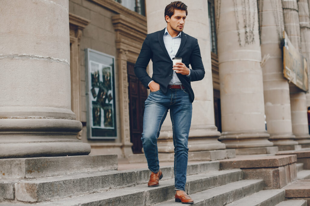 Man in a stylish suit. Businessman in a summer city. A male drinking a coffee. A male presentation of outfit combinations.